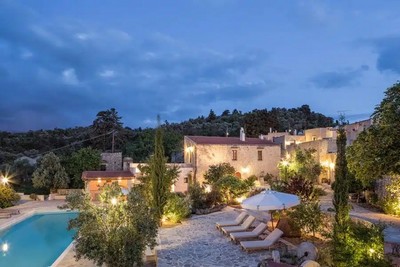 Charming evening view of Kapsaliana Village Hotel, showcasing its serene stone-built architecture, sparkling pool, and lush greenery. Charming evening view of Kapsaliana Village Hotel, showcasing its serene stone-built architecture, sparkling pool, and lush greenery.