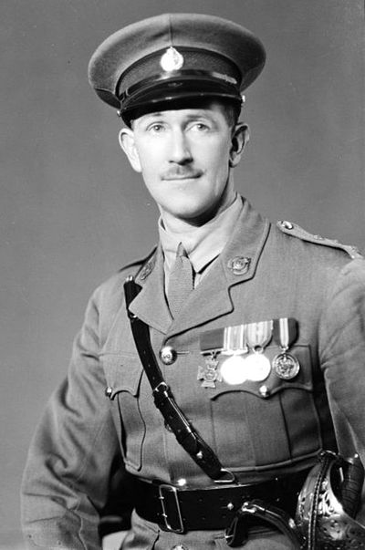 A black and white portrait of the distinguished military officer, Lieutenant Colonel Leslie Andrew, in full uniform, adorned with medals and a ceremonial belt. The officer wears a peaked cap and has a composed expression, indicative of honour and service. A black and white portrait of the distinguished military officer, Lieutenant Colonel Leslie Andrew, in full uniform, adorned with medals and a ceremonial belt. The officer wears a peaked cap and has a composed expression, indicative of honour and service.
