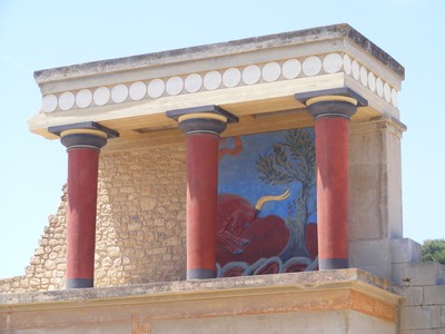 The reconstructed red and black columns of the iconic Knossos Palace in Crete, featuring an ancient fresco of a bull. The reconstructed red and black columns of the iconic Knossos Palace in Crete, featuring an ancient fresco of a bull.