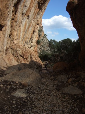 Majestic entrance to Sougia Gorge in Crete, featuring towering rock formations and a rugged, natural pathway leading into the wilderness. Majestic entrance to Sougia Gorge in Crete, featuring towering rock formations and a rugged, natural pathway leading into the wilderness.