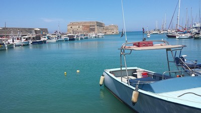 The picturesque Heraklion Harbour in Crete, featuring fishing boats and yachts with the historic Koules Fortress in the background. The picturesque Heraklion Harbour in Crete, featuring fishing boats and yachts with the historic Koules Fortress in the background.