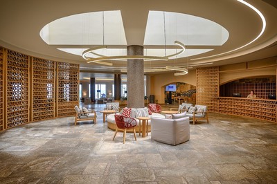 Elegant and modern hotel lobby with stylish seating arrangements, warm lighting, and a circular design that exudes sophistication and comfort. At he Creta Maris Beach Resort. Elegant and modern hotel lobby with stylish seating arrangements, warm lighting, and a circular design that exudes sophistication and comfort. At he Creta Maris Beach Resort.