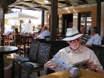 Man studying the menu in a Cretan cafe