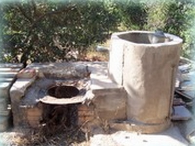 A traditional outdoor Raki distillation still in Crete, made of stone and metal, used for producing the famous Cretan Tsikoudia spirit. A traditional outdoor Raki distillation still in Crete, made of stone and metal, used for producing the famous Cretan Tsikoudia spirit.