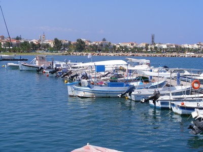 Small fishing boats docked at the harbor in Rethymnon, Crete, Greece, gently floating on calm blue waters. The picturesque waterfront is lined with trees and buildings in the background, capturing the peaceful charm of Rethymnon’s coastal scenery. Small fishing boats docked at the harbor in Rethymnon, Crete, Greece, gently floating on calm blue waters. The picturesque waterfront is lined with trees and buildings in the background, capturing the peaceful charm of Rethymnon’s coastal scenery.