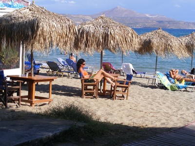 Woman sat on the beach reading